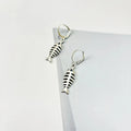 Fishbone pendant earrings and matching necklace set with adjustable chain on grey background