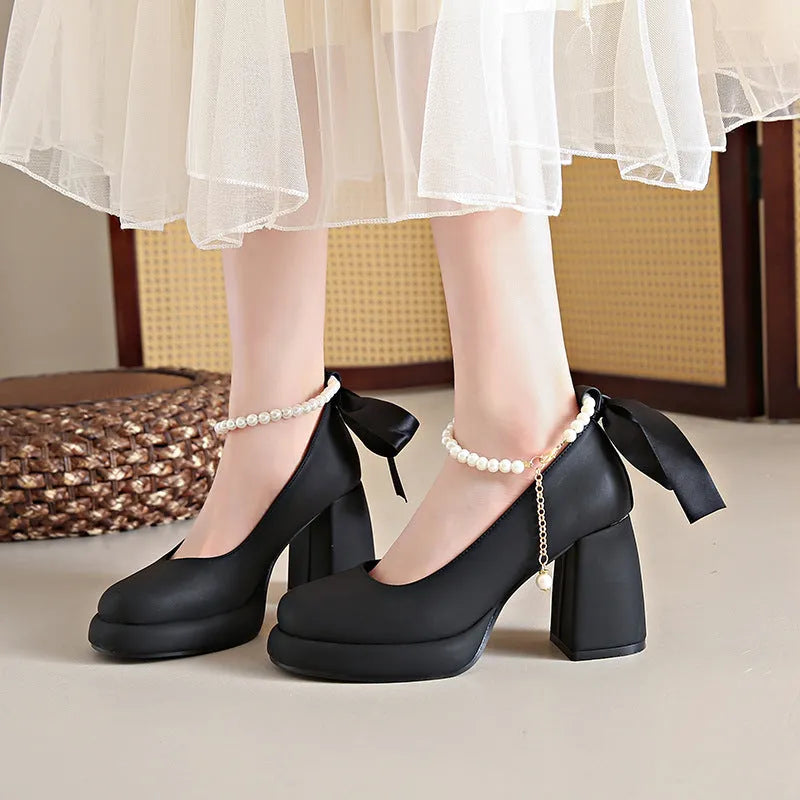Beige women's Mary Jane shoes with a chunky heel and an ankle-strap buckle on a round toe.