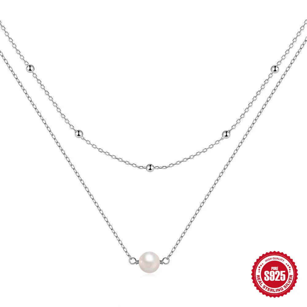 S925 sterling silver double layer necklace with twin diamond-treated pearls and geometric design.