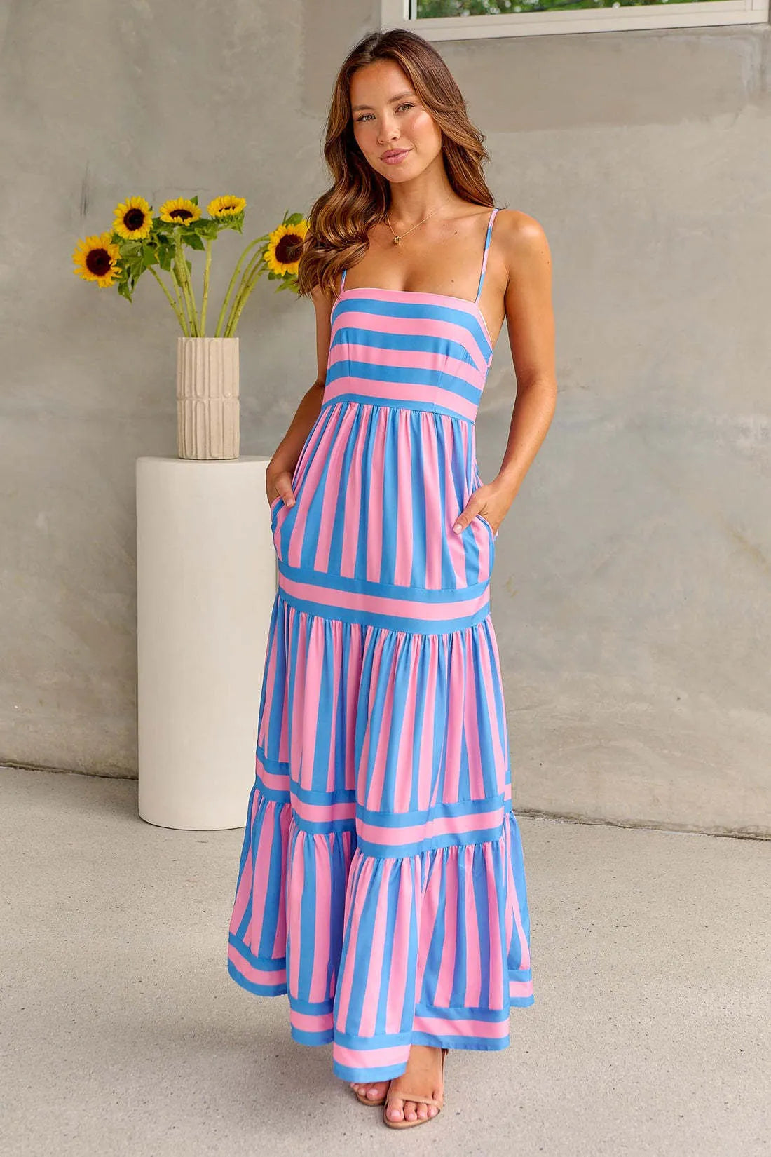 Women's striped backless suspender long dress with square neckline and pockets.