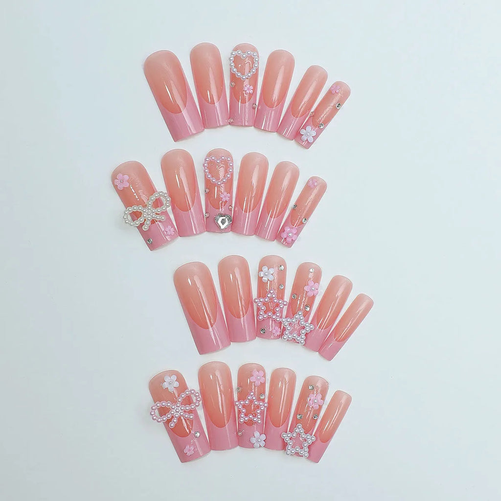 French style stick-on false nails with a love pattern and bow detail in colour XB-70-48 on a plastic armour suit.