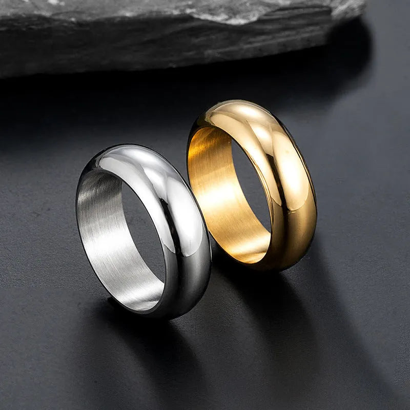 A glossy electroplated titanium steel ring shown in gold, black, and steel colour options on a plain background.