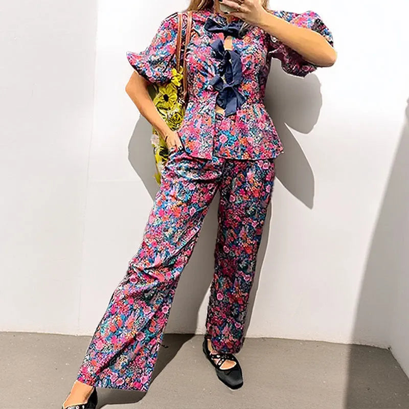 Leisure floral printed tie-neck trousers suit with puff sleeves, shown in picture colour.