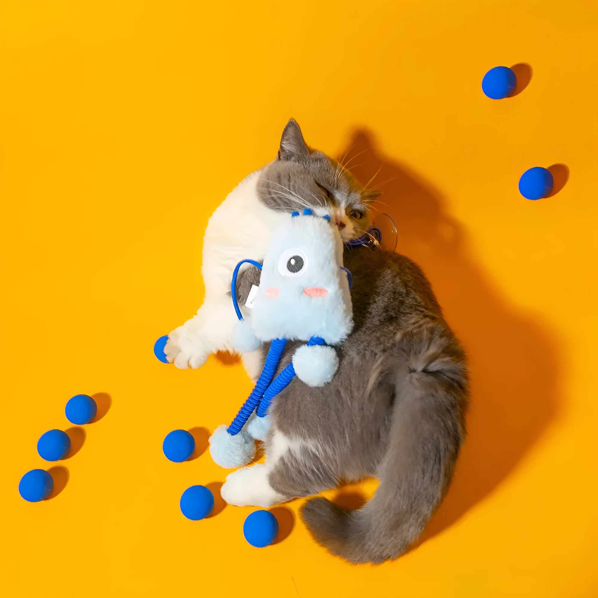 Blue four-ring soft plush cat toy with elastic rope and a mint bell.