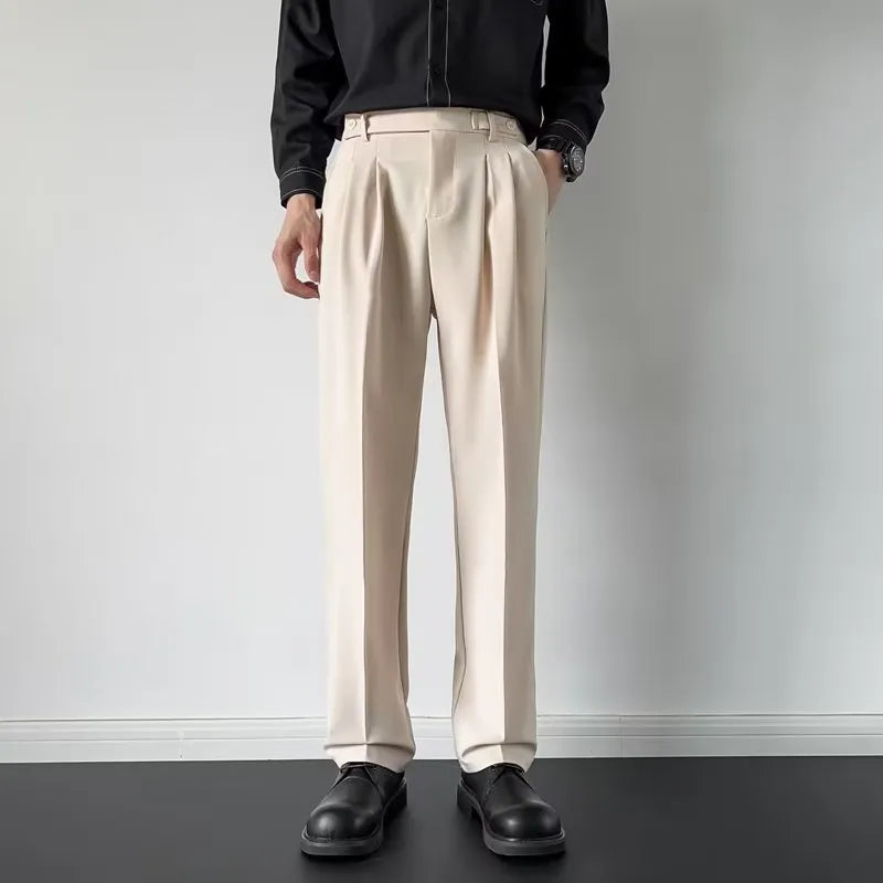 Man wearing apricot coloured straight-leg loose-fit suit pants made from polyester fibre.