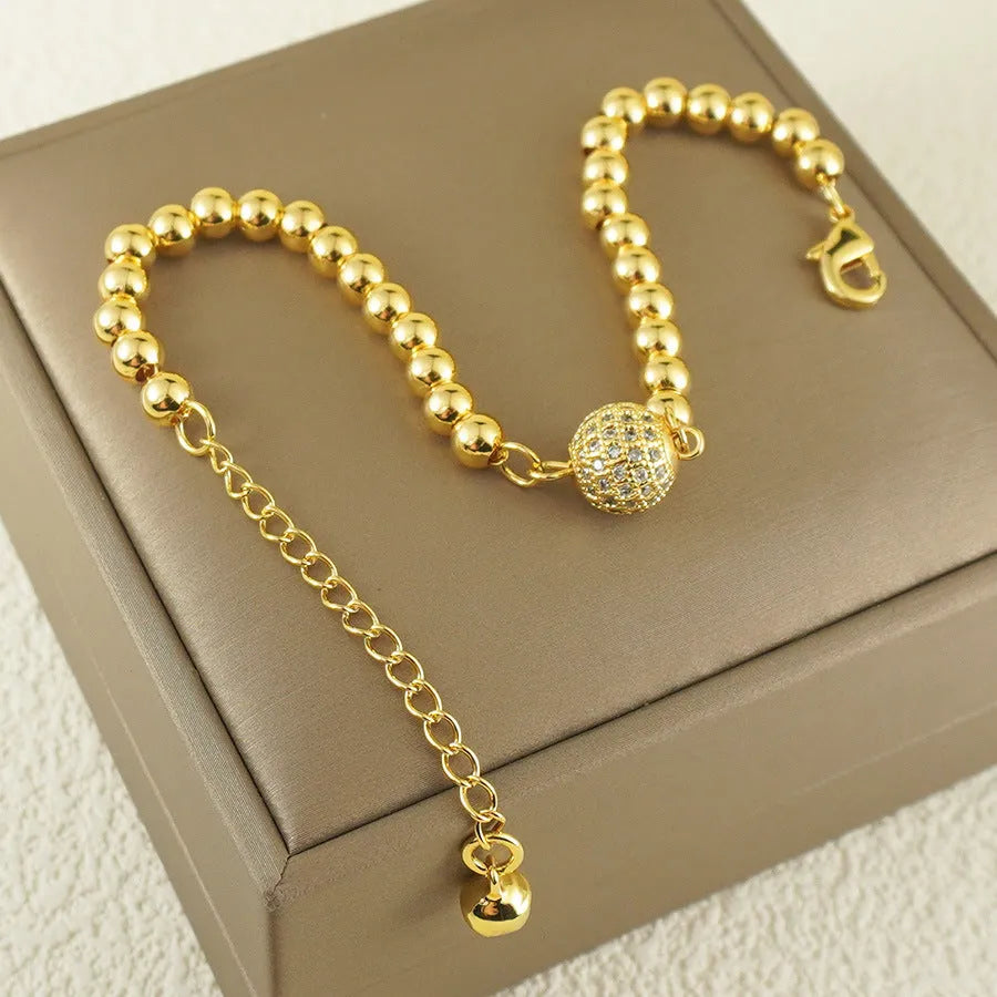 Copper bracelet with heart-shaped Arabic design and single zircon centrepiece on white background