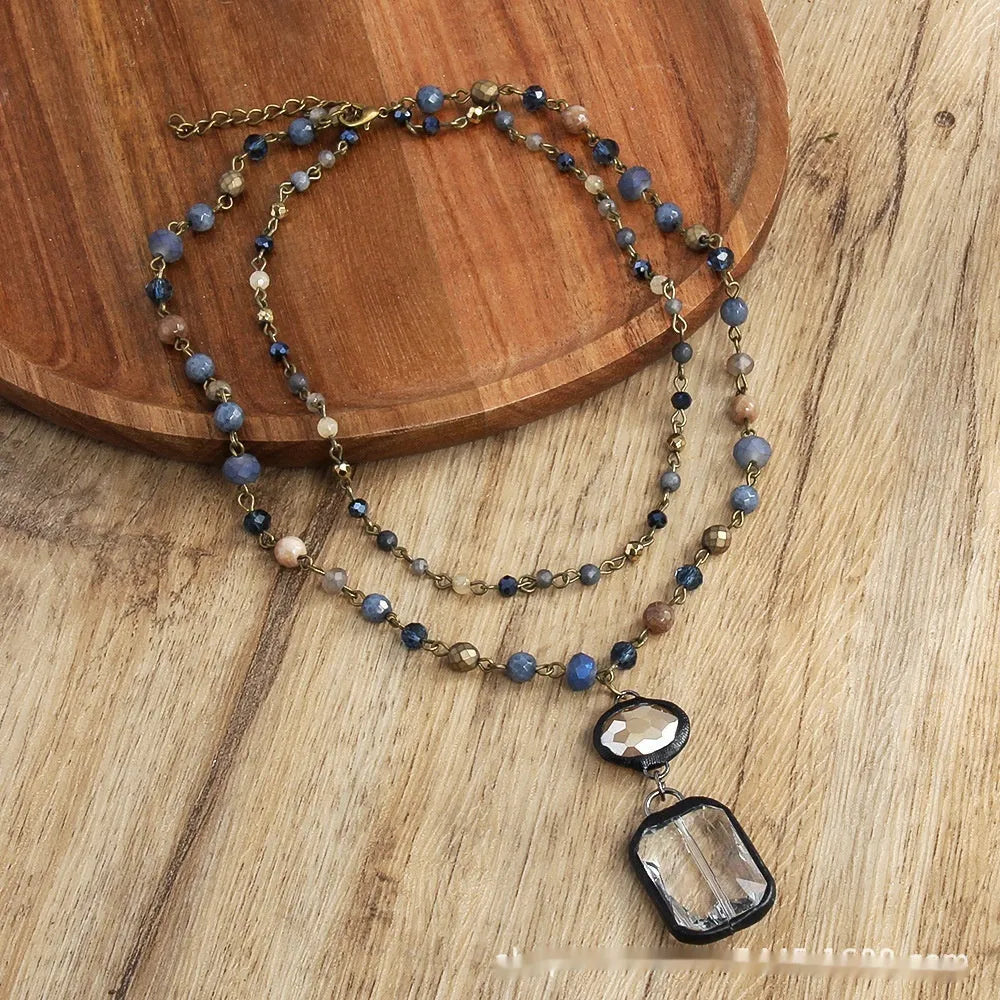 Tribal style two-layer necklace with glass and stone pendants in beige and blue on adjustable chain
