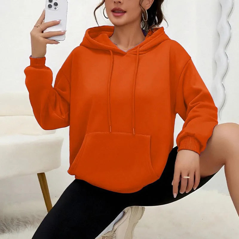 Women's loose grey drawstring pocket sweatshirt with long sleeves on a hanger.
