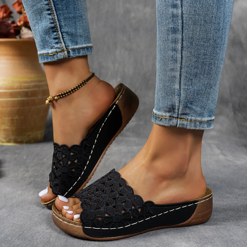 Women's wedge beach slippers with flower cutout design on PVC upper and fish-mouth toe shape.