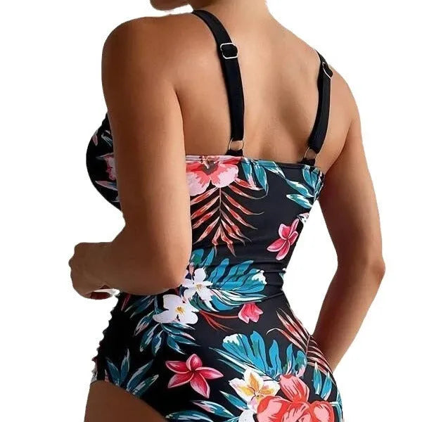 Women's black floral backless one-piece swimsuit on a model, showing spandex lining and high elasticity fit.
