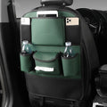 Black leather storage bag hanging on the back of a car seat.
