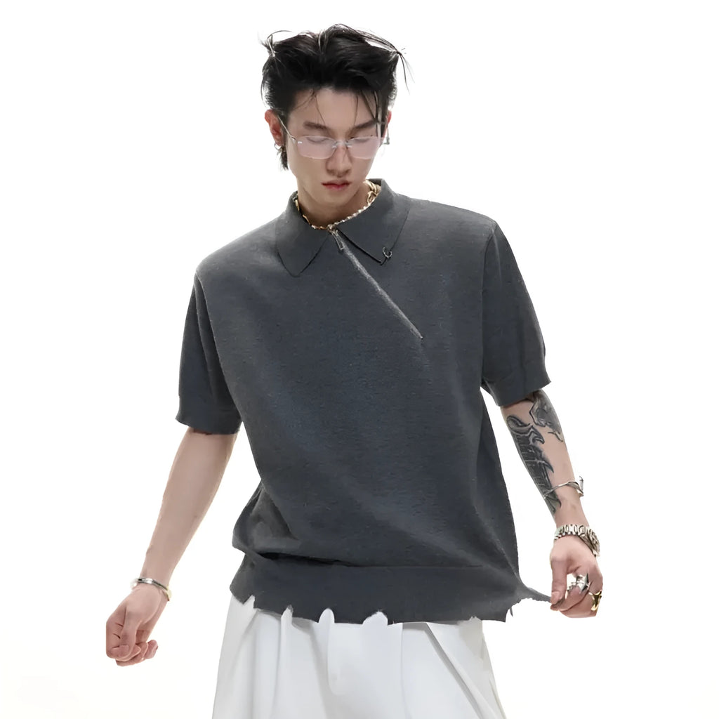 Man modelling a slim-fit black knitted polo shirt with an oblique zip and short sleeves.