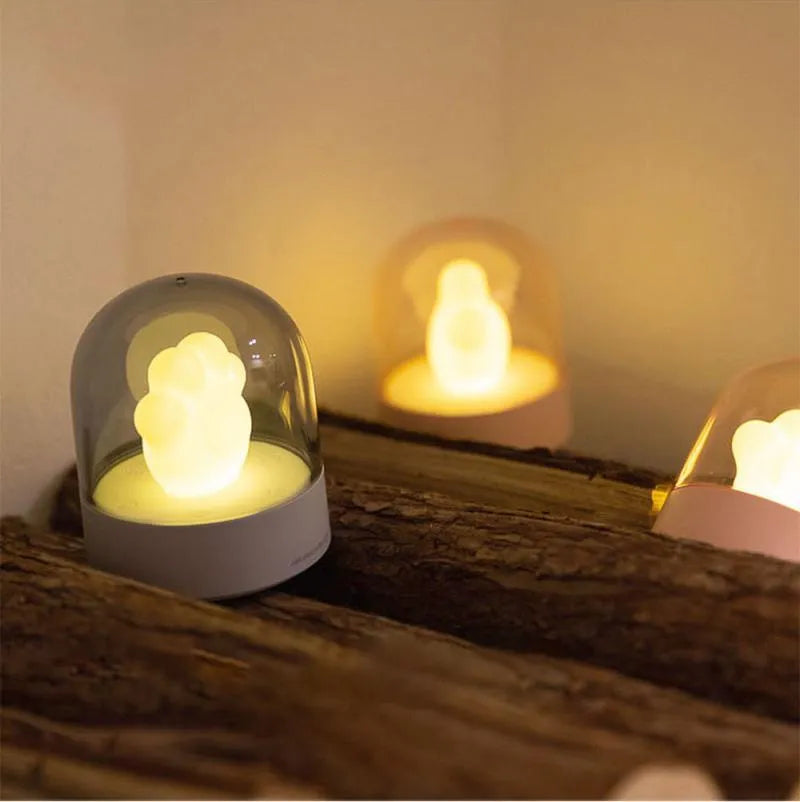 Grey or pink cat paw shaped night light with USB charging port and music box functionality