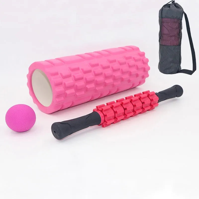 Black handheld foam massage roller bar with six white textured gear pieces on a 33cm shaft.