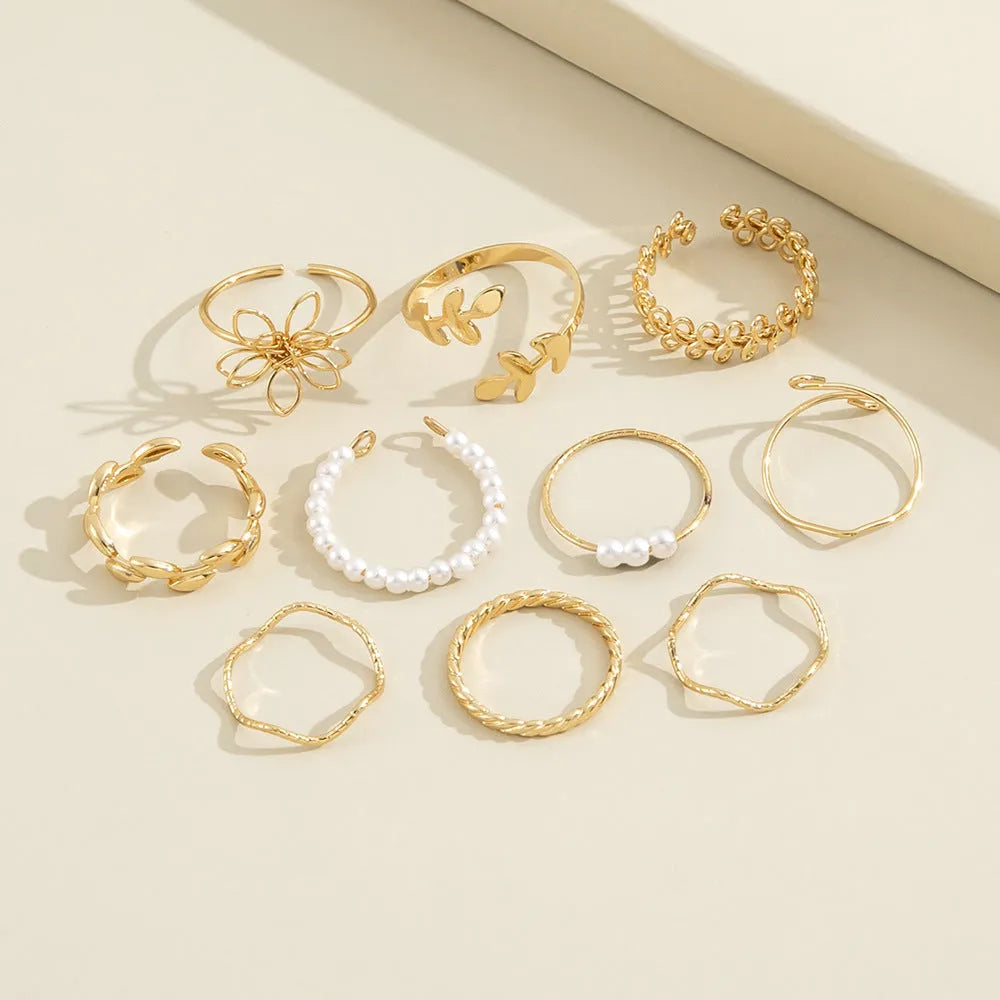Gold openwork floral pattern alloy ring with electroplated glossy finish