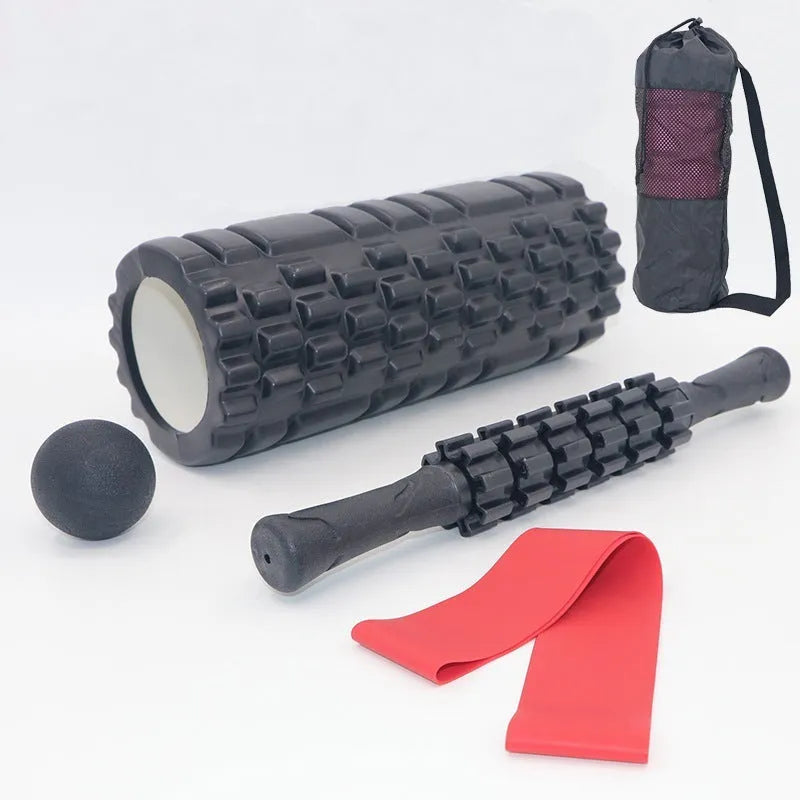 Black handheld foam massage roller bar with six white textured gear pieces on a 33cm shaft.