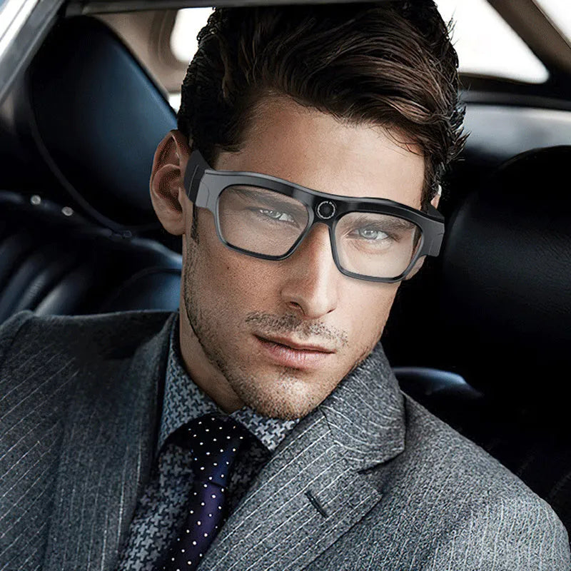 Black head-mounted smart Bluetooth glasses with a camera, shown with a data cable and glasses cloth.