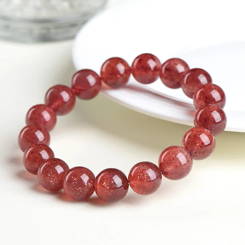 Natural cherry red strawberry quartz bracelet with geometric cut stones on wrist