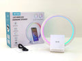White smart Bluetooth speaker with ambient light and 15W wireless charging pad on desk