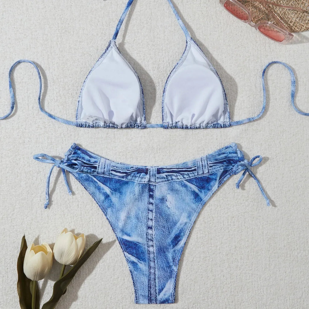 Women's denim blue printed bikini set with halterneck top and side-tie bottoms on a mannequin.