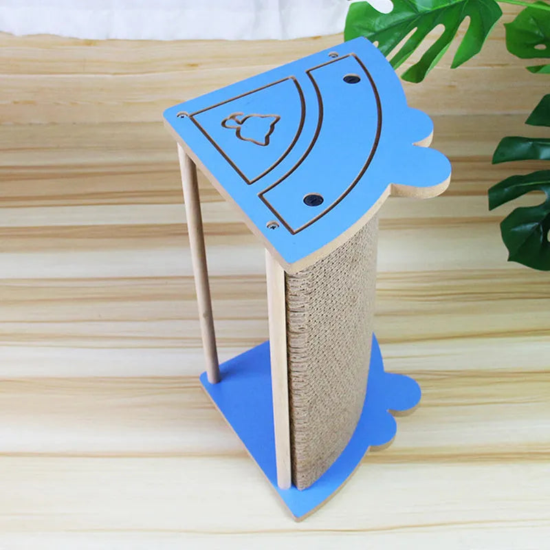 Triangular cardboard cat corner scratcher with hanging ball toy against wall