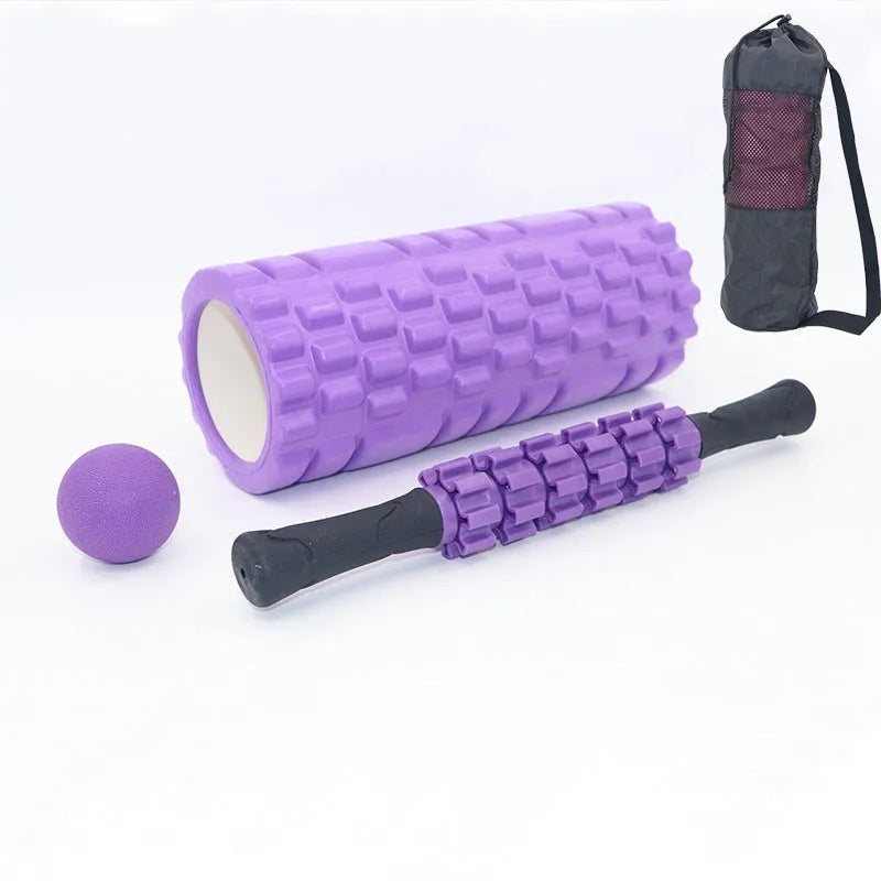 Black handheld foam massage roller bar with six white textured gear pieces on a 33cm shaft.