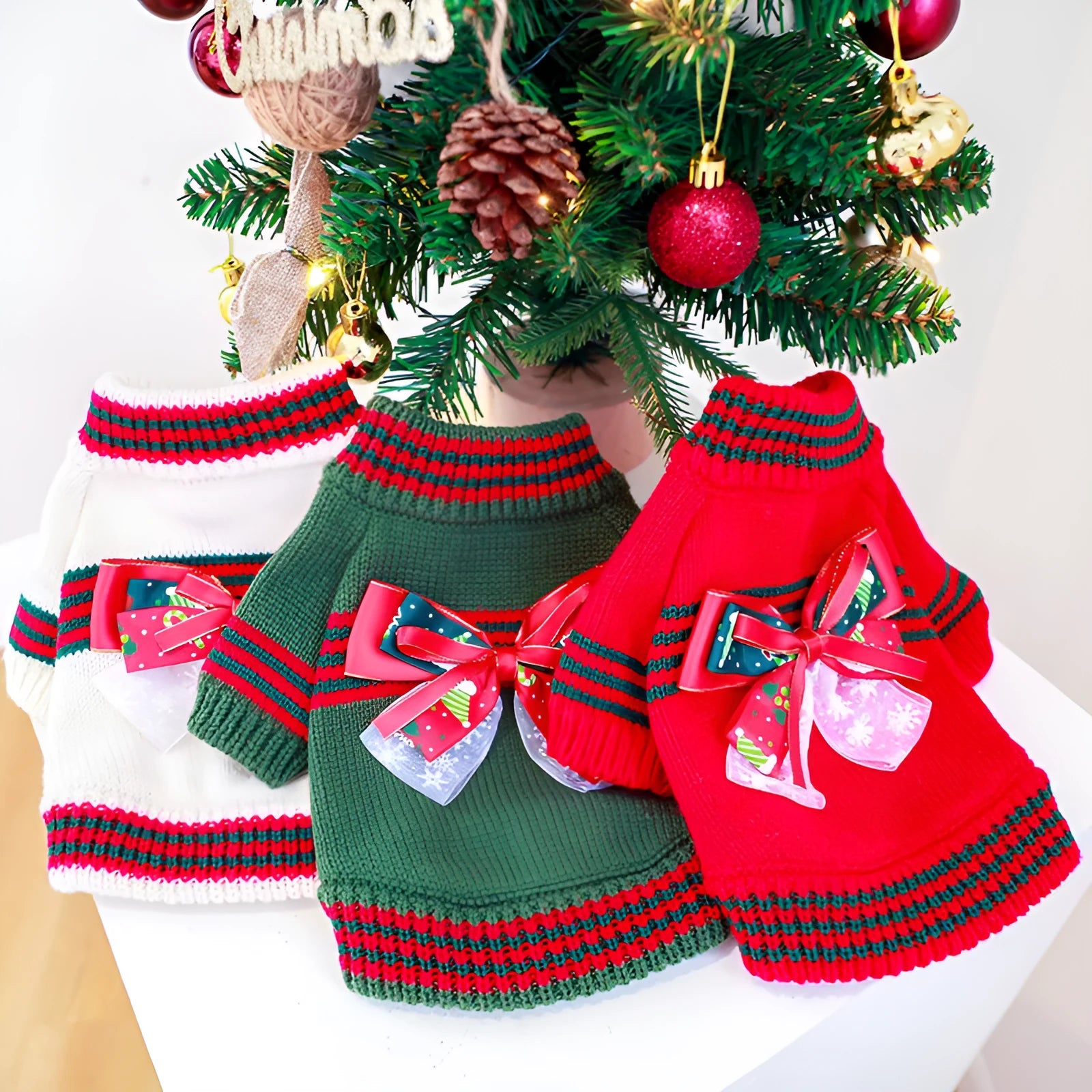 Red Christmas sweater for a small dog on a festive background, showing the 'Merry Christmas' print and pullover style.