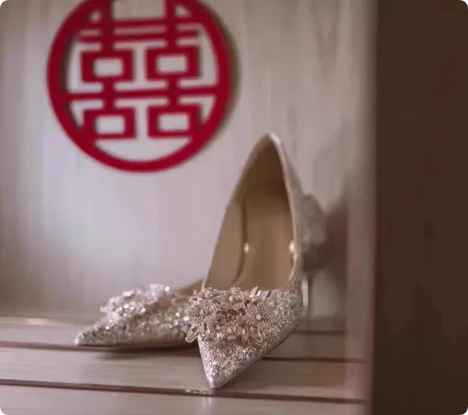 Champagne coloured women's wedding shoes with crystal rhinestones and a pointed toe, shown with a high heel.
