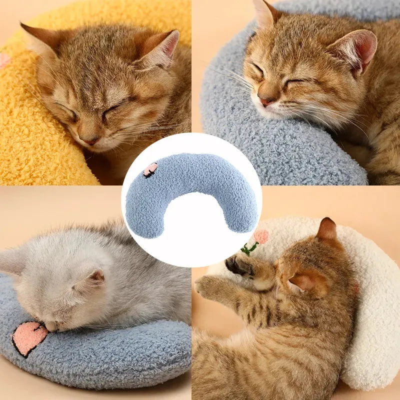 Small U-shaped plush pet pillow in blue for cats and small dogs, showing quilted faux fur texture.