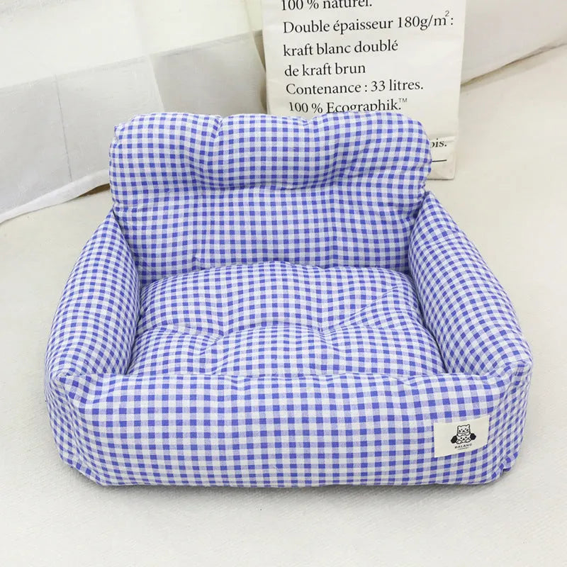 Car-mounted pet travel nest in stain-resistant cloth fabric showing grey and blue plaid colour options