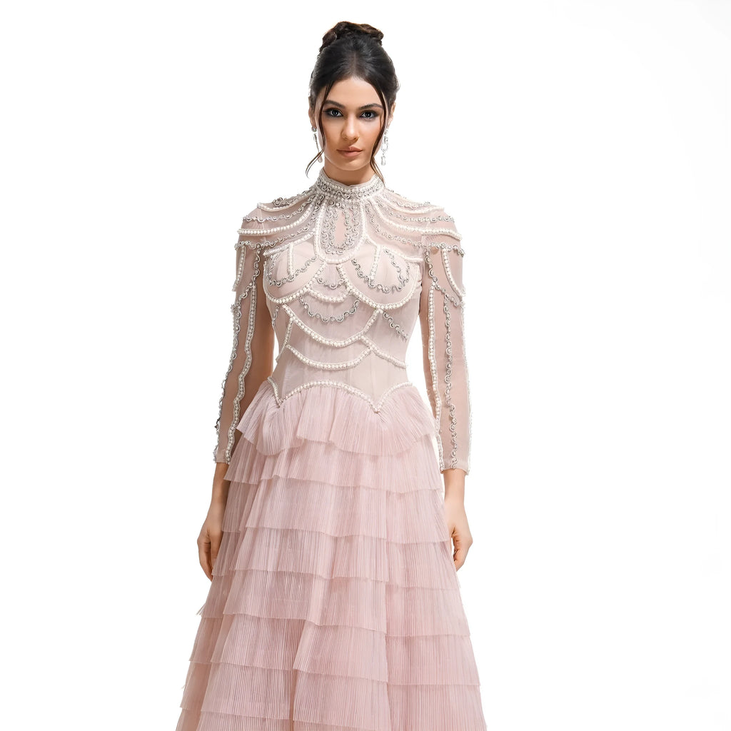 Women's long sleeve black dress with beaded decoration and a full-length skirt.