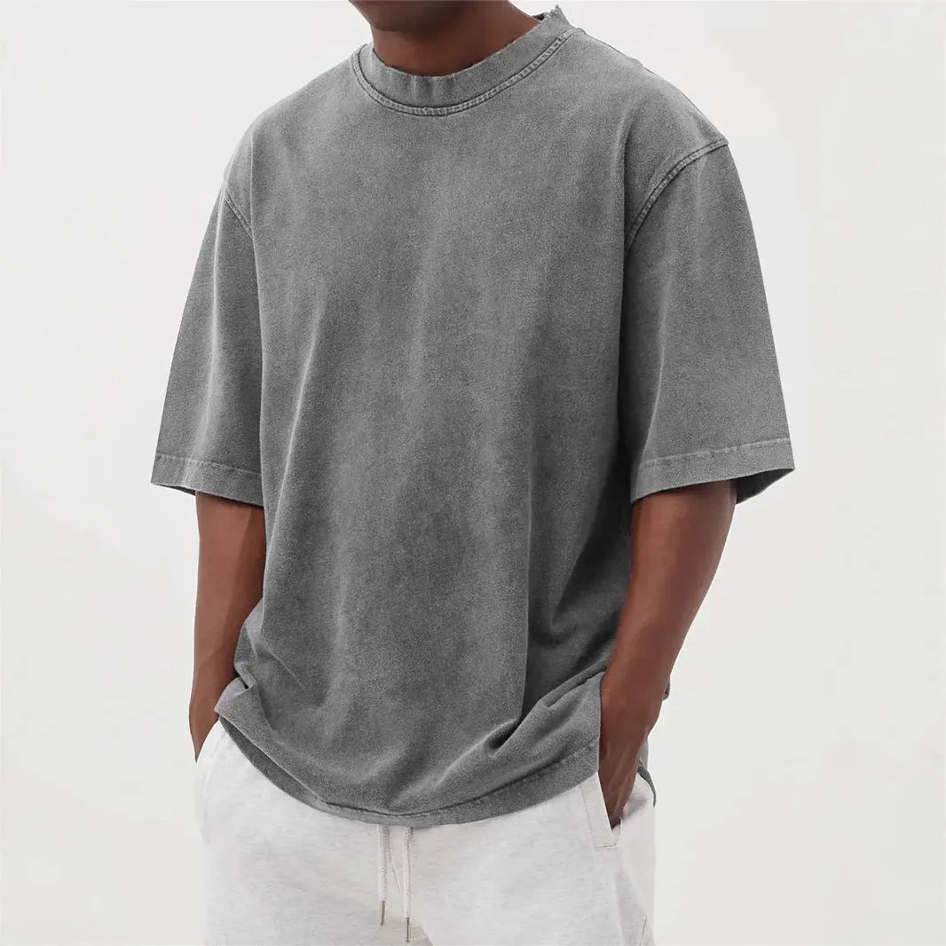 Men's loose fit stone washed polyester t-shirt in army green colour, showing distressed texture and short sleeves.