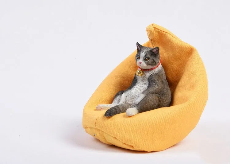 Lazy cat ornament with miniature sofa on car dashboard - 7.5cm resin decoration