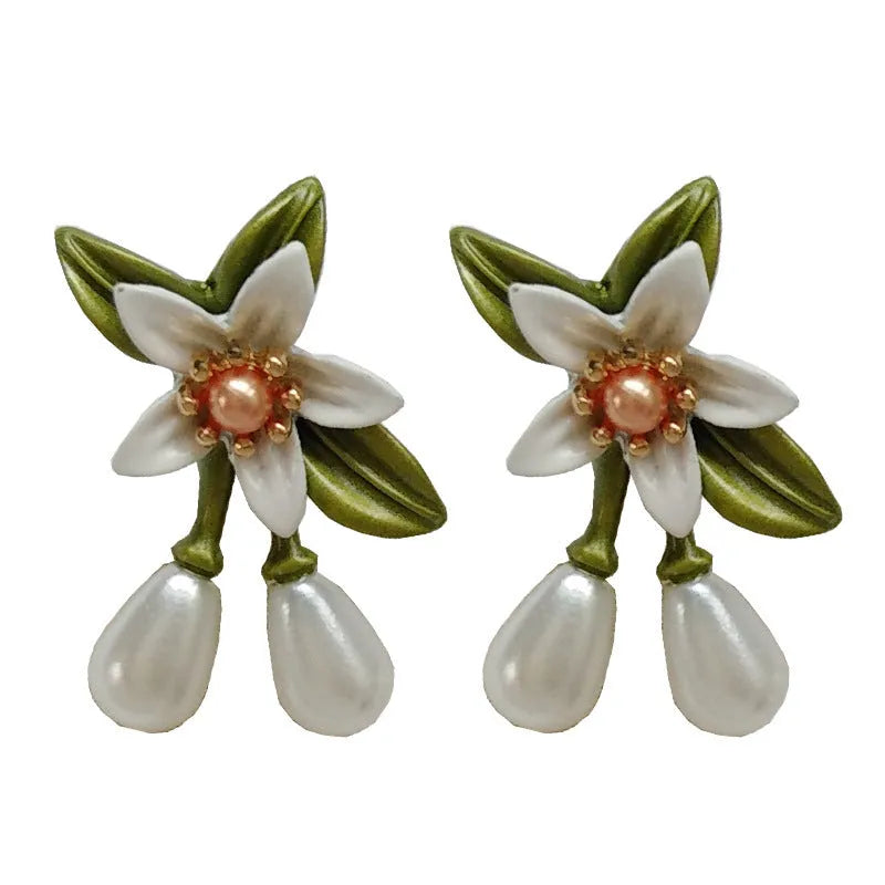 Alloy flower ear stud and matching clip-on earring pair with sterling silver needle camellia design.