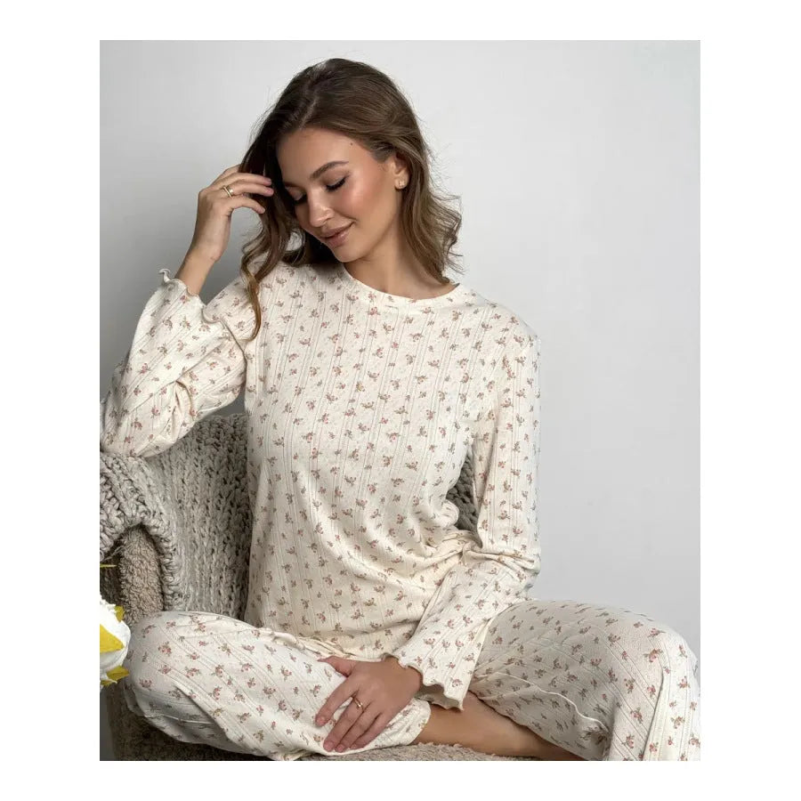 White floral print women's pyjama set with bell sleeve top and wide-leg trousers.