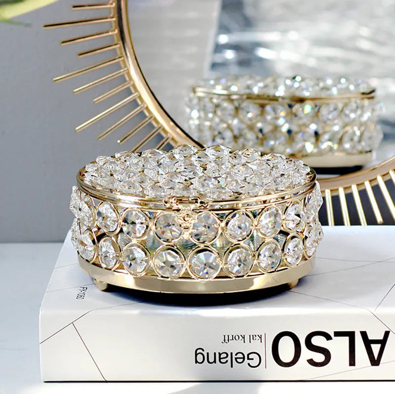 French gold metal jewelry box with a clear crystal glass front panel on display.