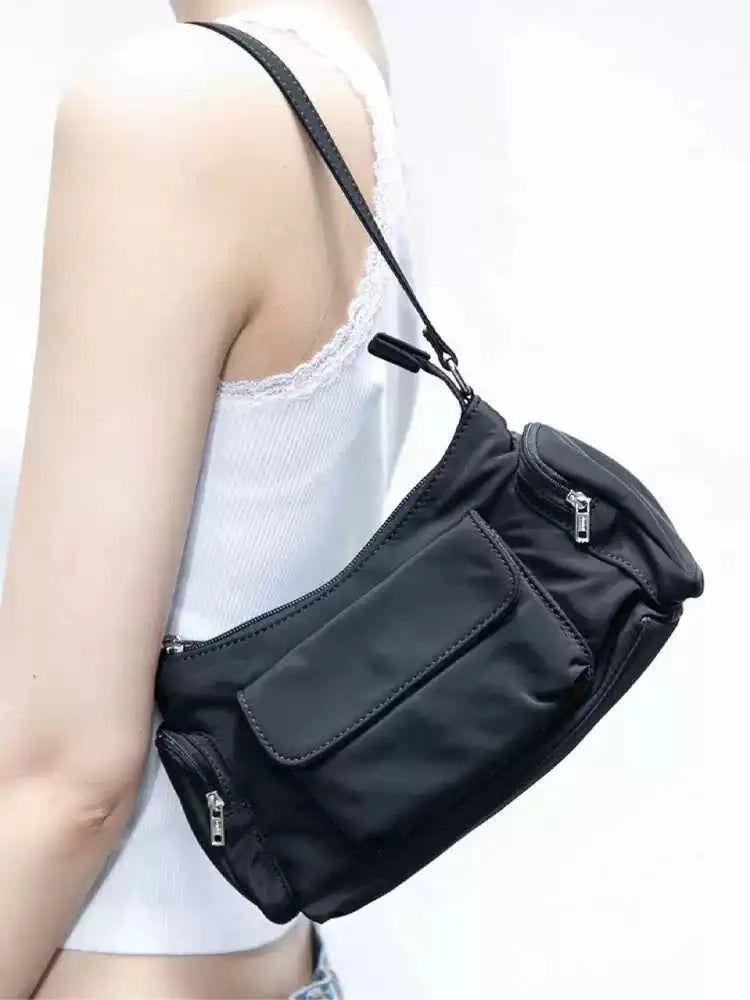 Black lightweight women's shoulder bag with double pockets and side line detail