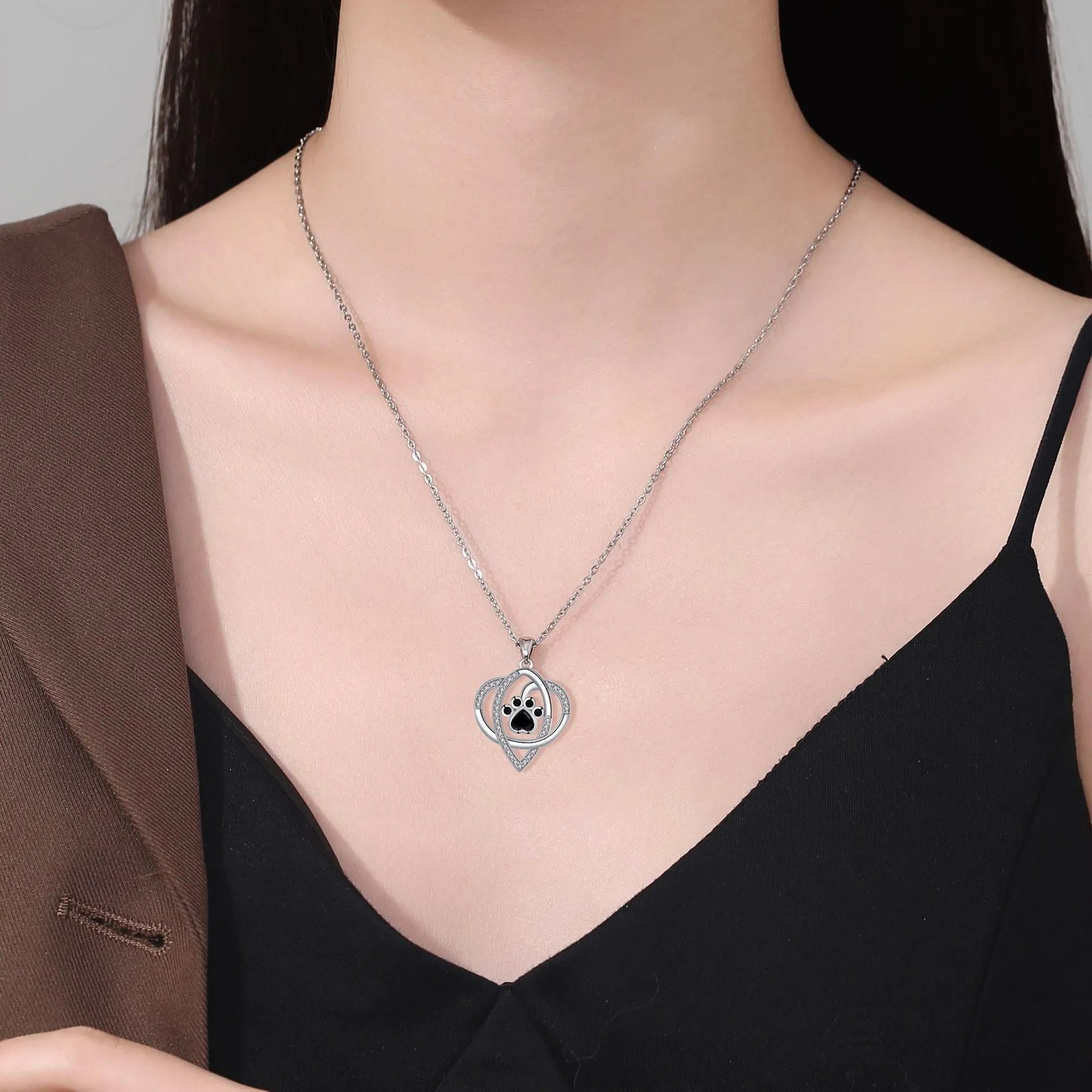 Silver tone necklace with cat and dog paw print pendant on cross chain for women
