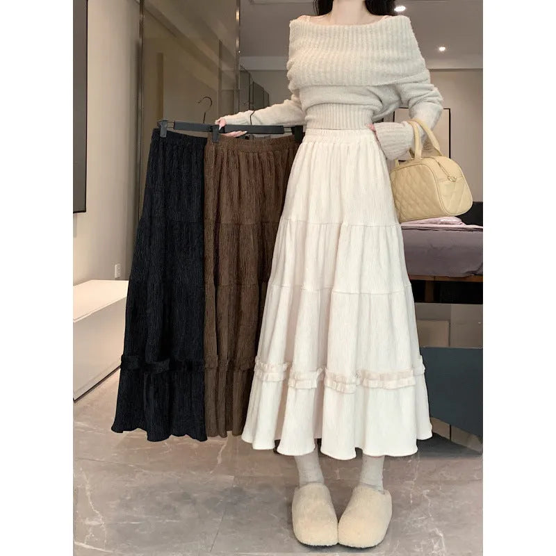 Korean style corduroy A-line midi skirt with elastic waistband in solid colour on hanger.