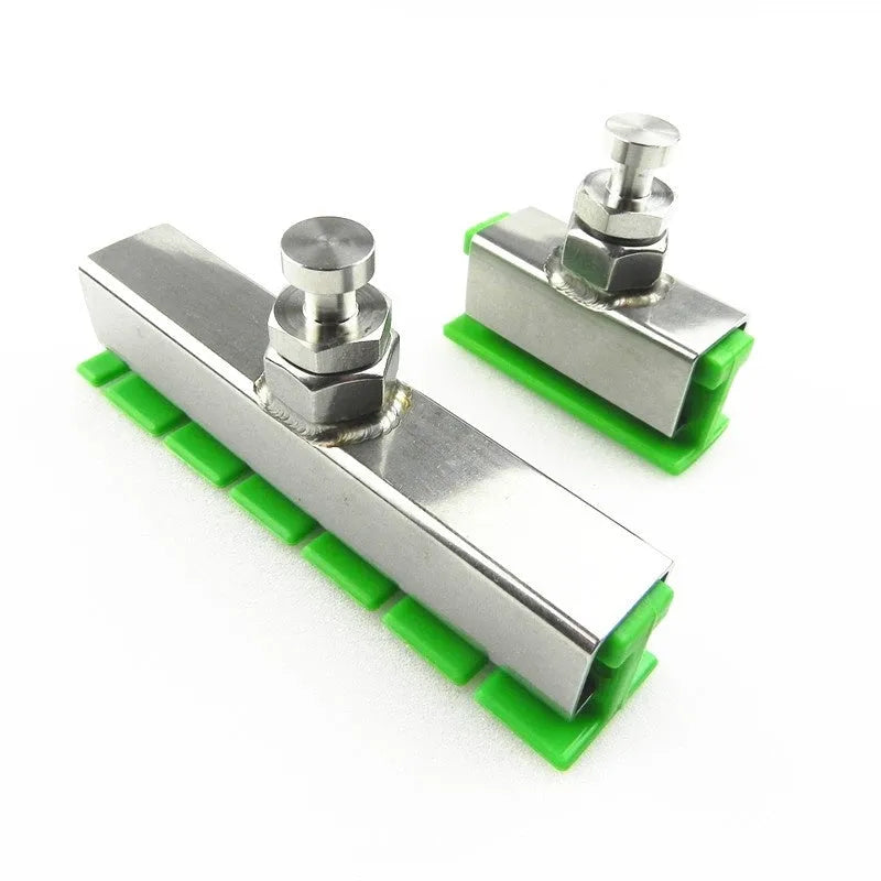 Car dent repair tool set with green adhesive labels and aluminium alloy supports on a workbench