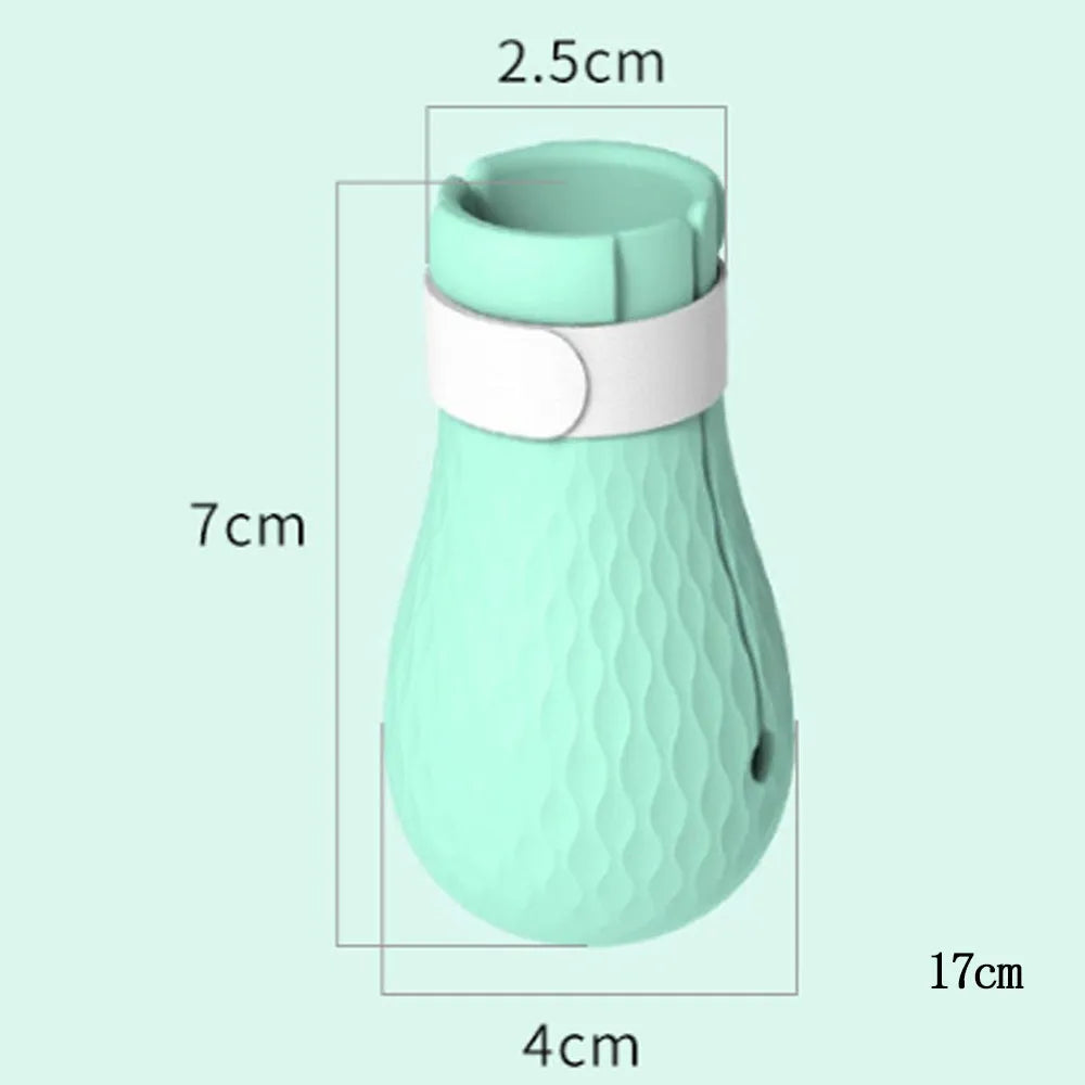 Four green silicone cat scratch prevention foot covers with an adjustable strap laid flat