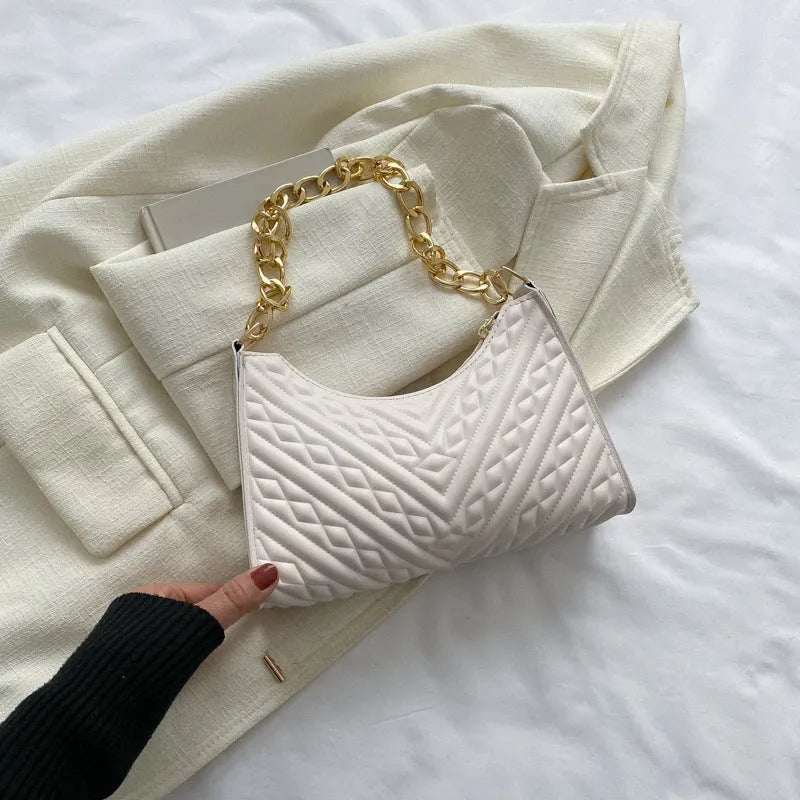 Brown pleated chain strap baguette shoulder bag with a vertical square shape and soft carry handle.