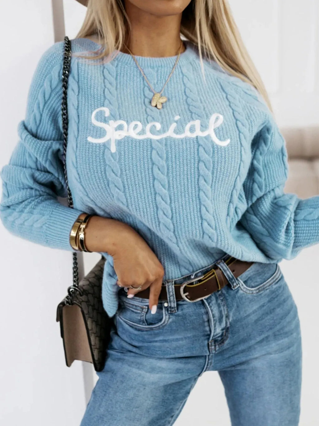 Blue men's crew neck sweater with embroidered letters and numbers on the chest.