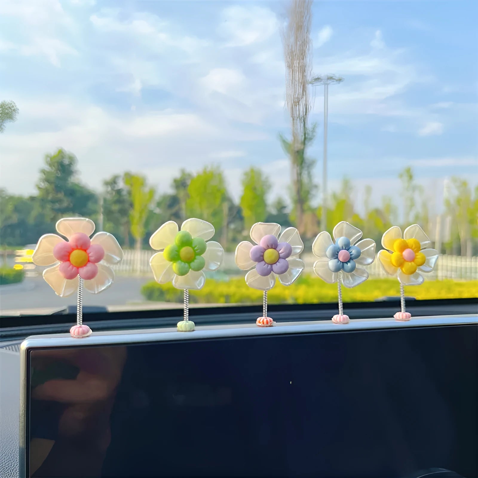 Small colourful plastic swing decoration for car interior, approx. 5cm tall.