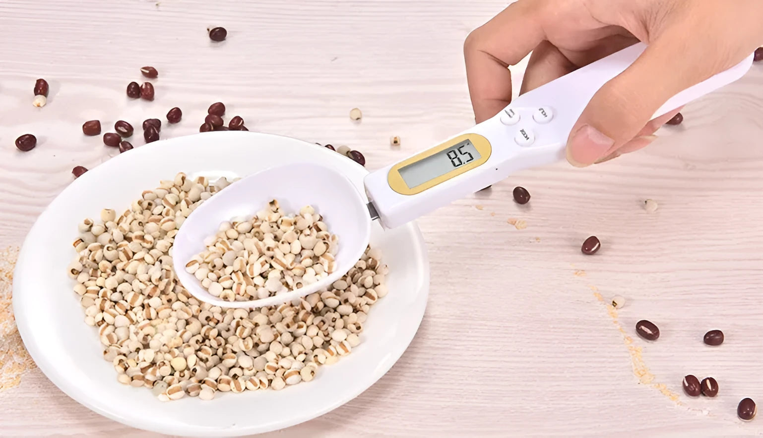 Black electronic measuring spoon scale showing digital display, placed on a kitchen counter.