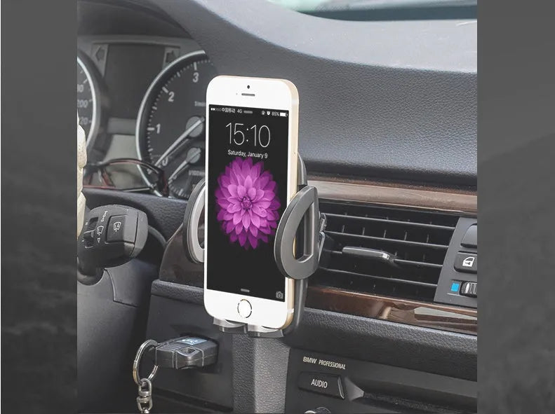 Black plastic mobile phone holder mounted on car air conditioning vent