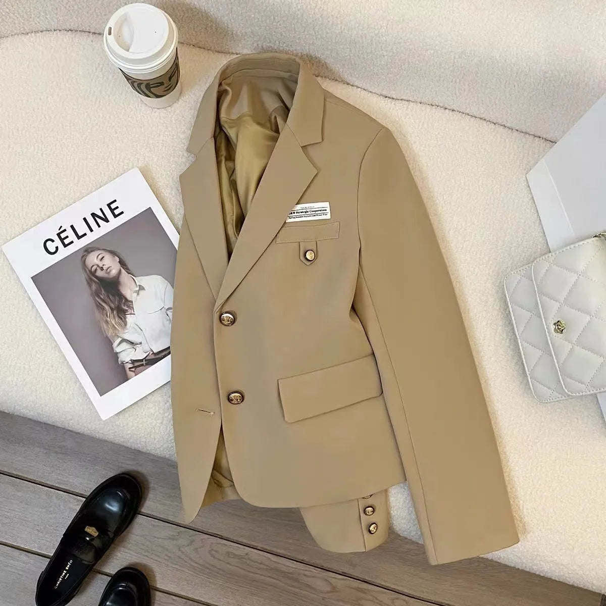 Women's black short suit coat with loose fit design and regular sleeves