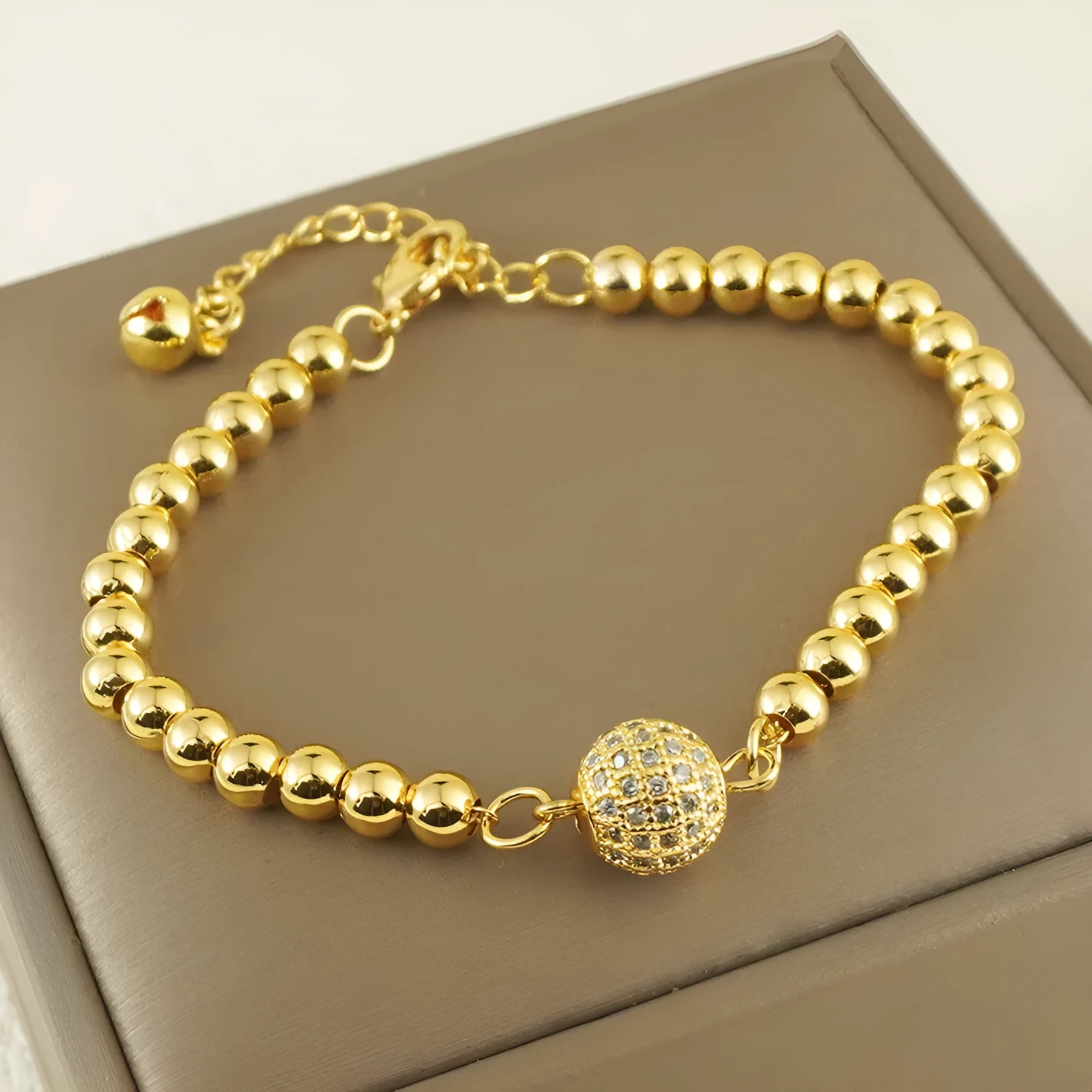 Copper bracelet with heart-shaped Arabic design and single zircon centrepiece on white background