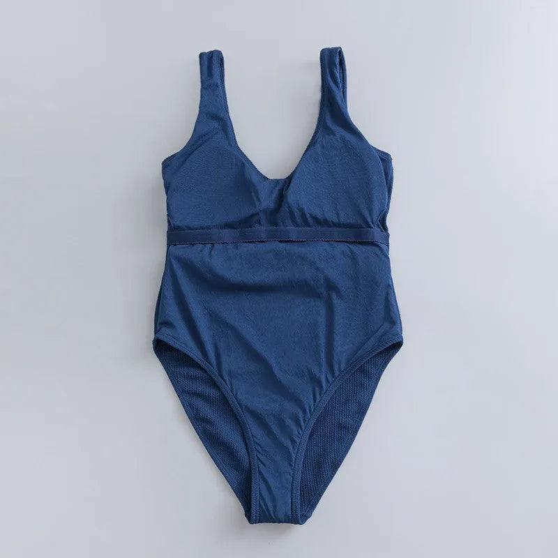 Navy blue women's one-piece slimming triangle swimsuit with chest pads on mannequin
