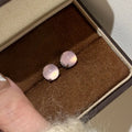 Round egg surface chalcedony stud earrings with four-claw copper setting in emerald green colour